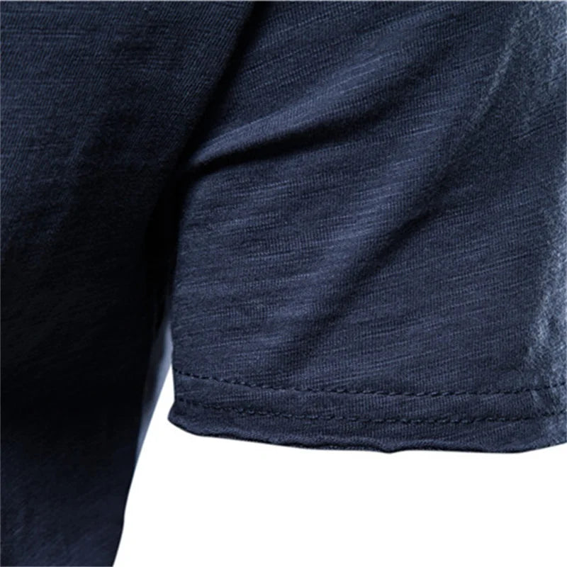 Navy 100% cotton men's T-shirt sleeve hem with soft, breathable fabric and neat stitching.