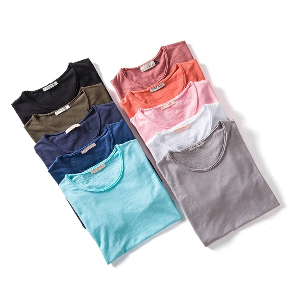 Assorted 100% cotton men’s T-shirts in a neatly folded stack.